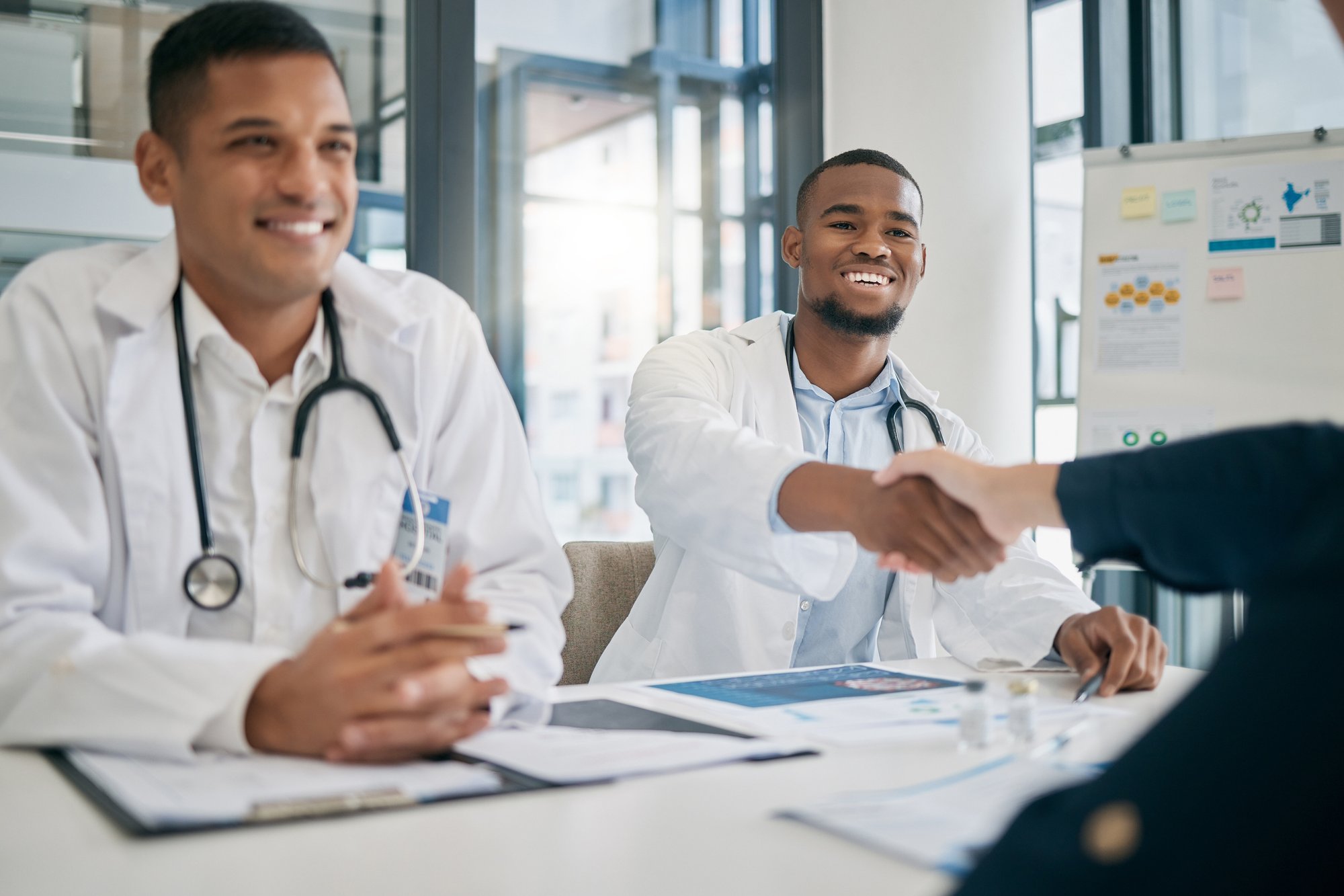 doctor-handshake-and-meeting-with-patient-smile-2023-11-27-05-36-29-utc